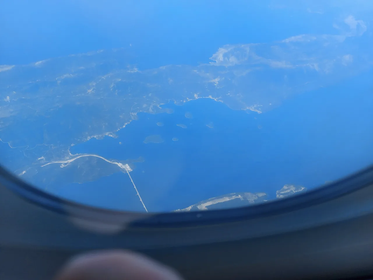 View from an aircraft window over the Pelješac Bridge and the channel it crosses